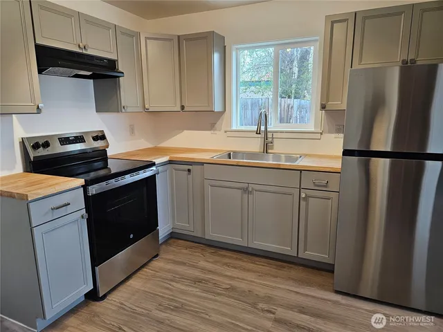a kitchen with a sink stove and refrigerator