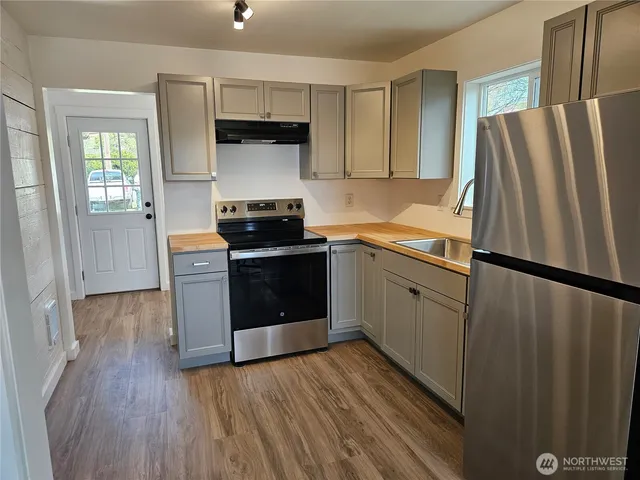 a kitchen with stainless steel appliances a refrigerator stove and sink