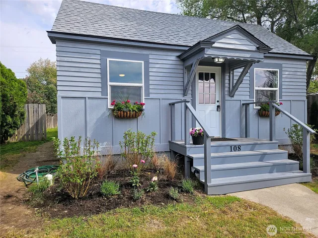 a front view of house with a garden