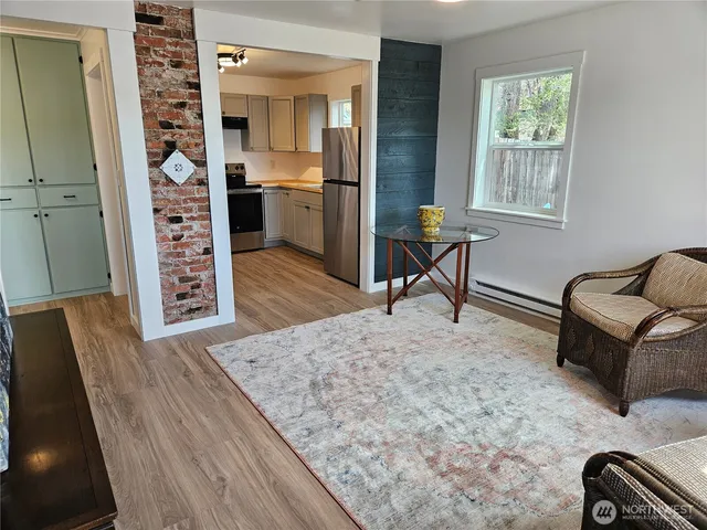 a utility room with wooden floor washer and dryer