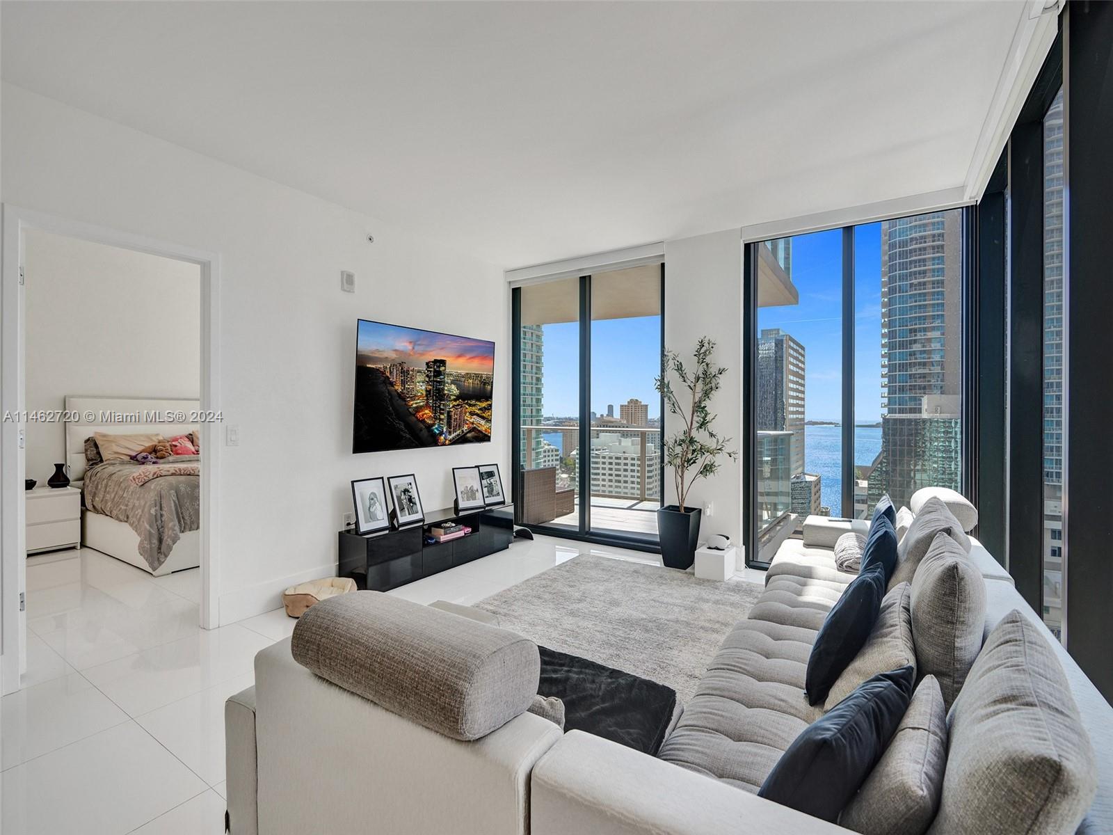 1010 Brickell Avenue, Unit 2505 Miami, FL 33131 - Photo 11 of 61 a living room with furniture and a flat screen tv