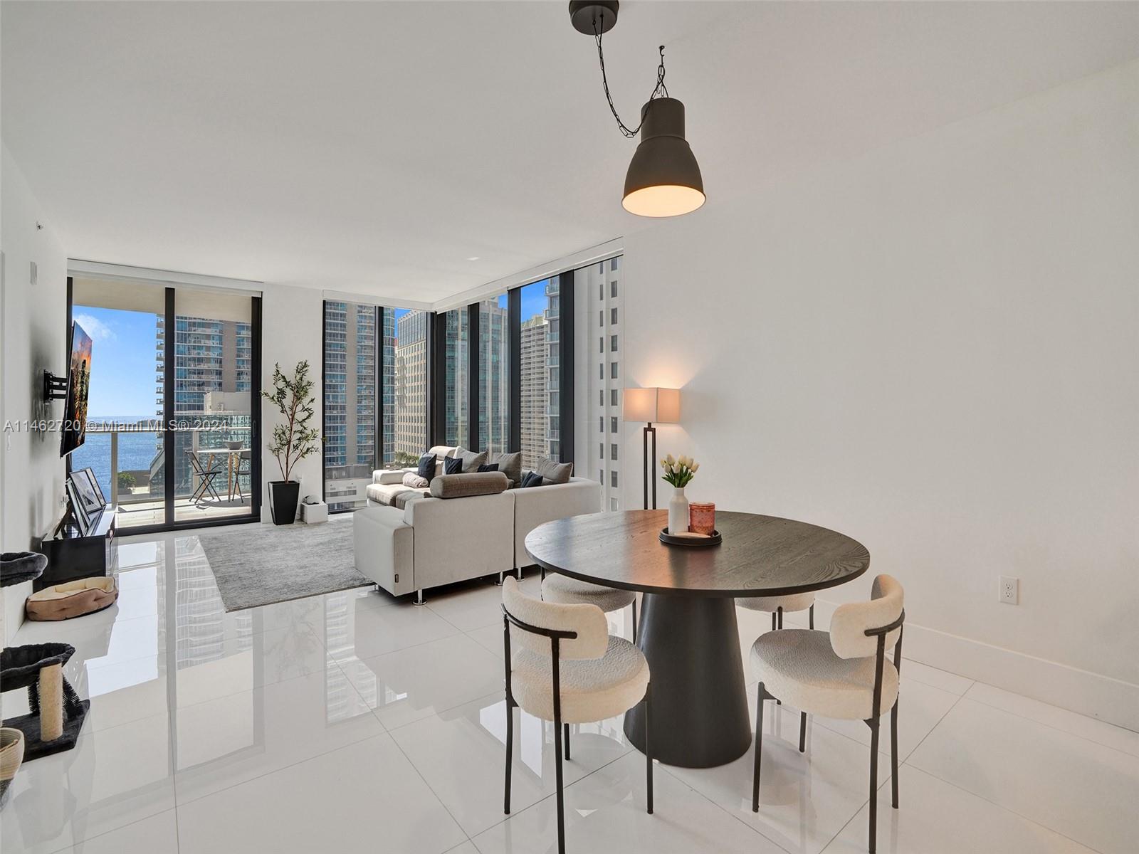 1010 Brickell Avenue, Unit 2505 Miami, FL 33131 - Photo 15 of 61 a dining room with furniture and wooden floor