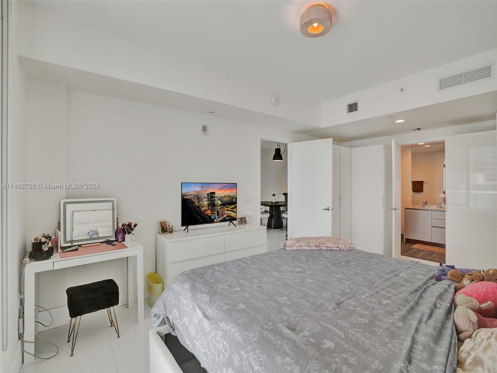 1010 Brickell Avenue, Unit 2505 Miami, FL 33131 - Photo 18 of 61 a bedroom with a bed and a flat screen tv