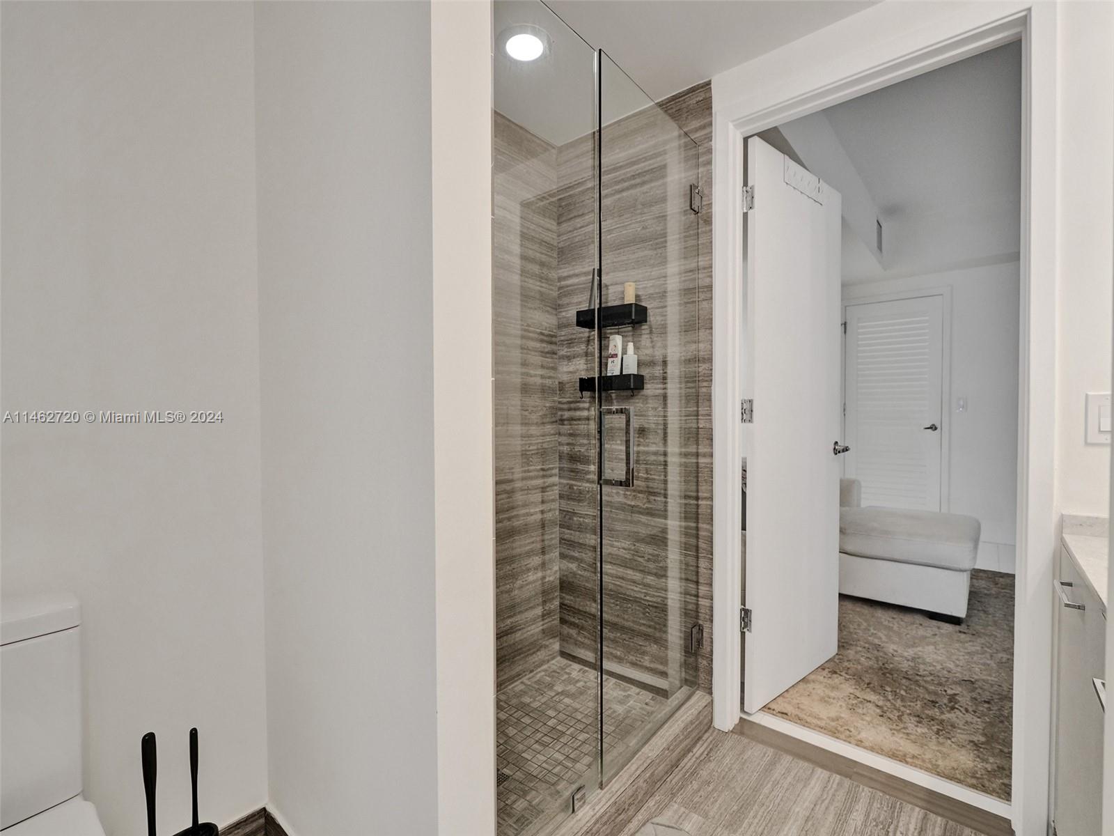1010 Brickell Avenue, Unit 2505 Miami, FL 33131 - Photo 22 of 61 a bathroom with a shower and a glass door