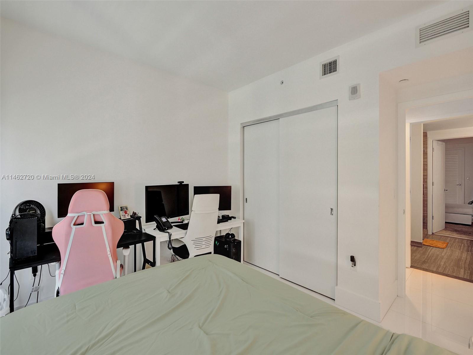 1010 Brickell Avenue, Unit 2505 Miami, FL 33131 - Photo 24 of 61 a bedroom with a bed and flat tv screen on the dresser