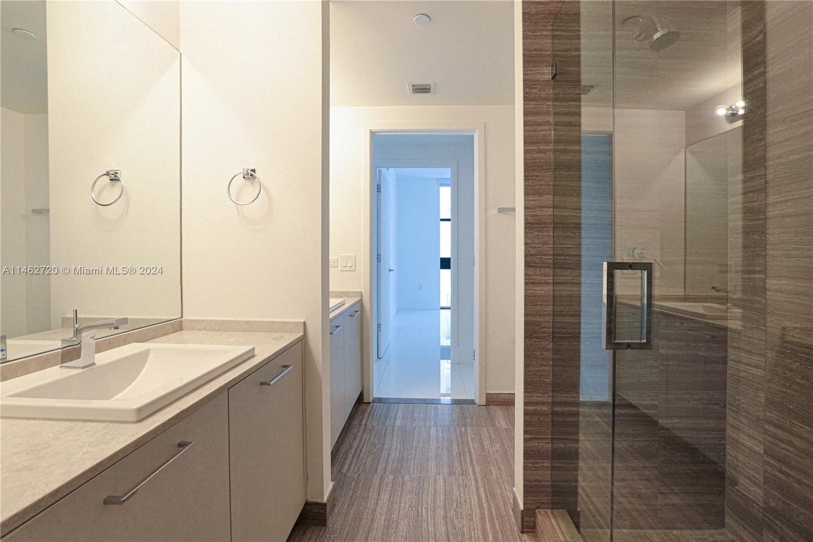 1010 Brickell Avenue, Unit 2505 Miami, FL 33131 - Photo 29 of 61 a bathroom with a sink and a mirror