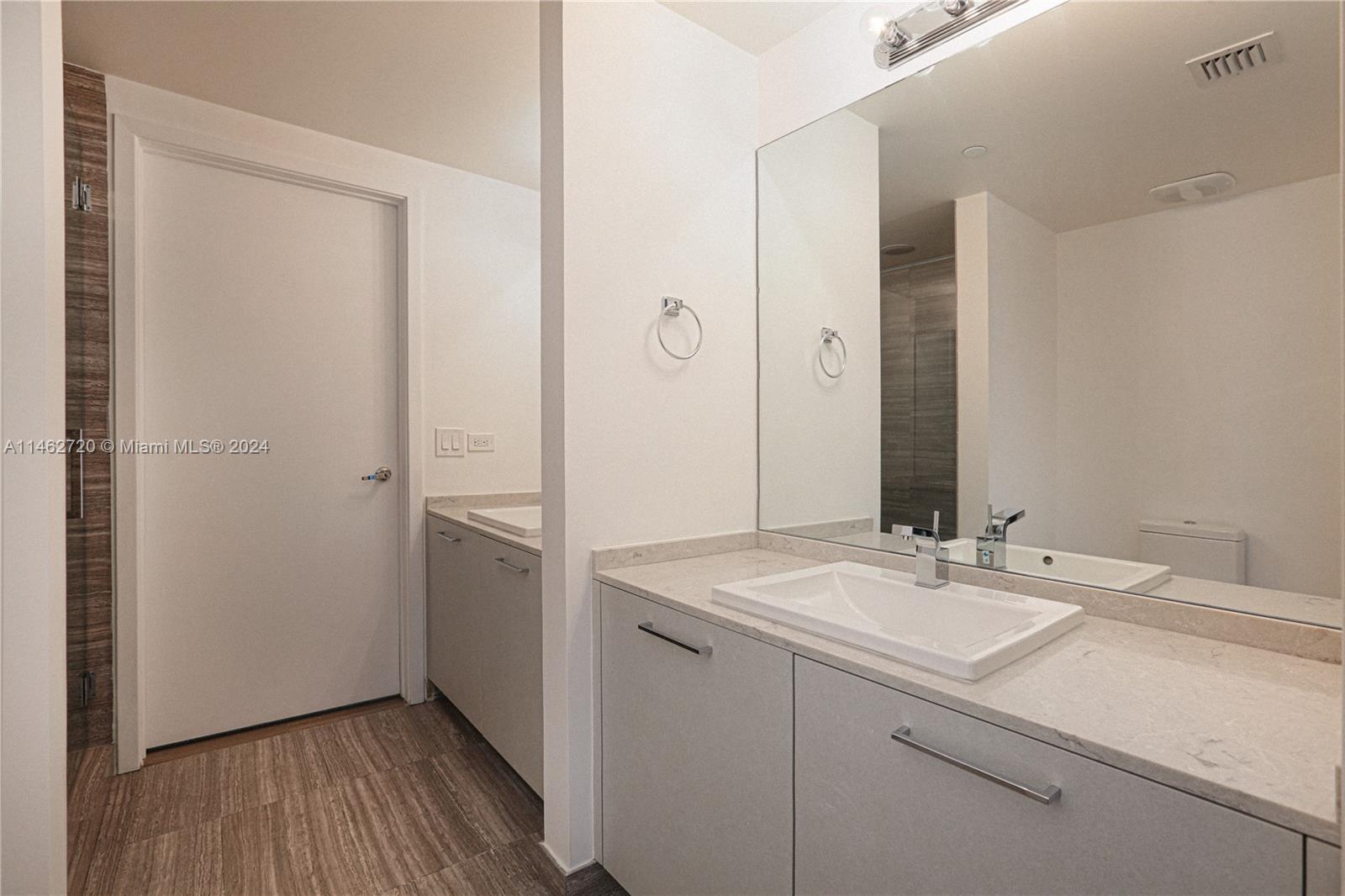 1010 Brickell Avenue, Unit 2505 Miami, FL 33131 - Photo 30 of 61 a bathroom with a sink and a mirror