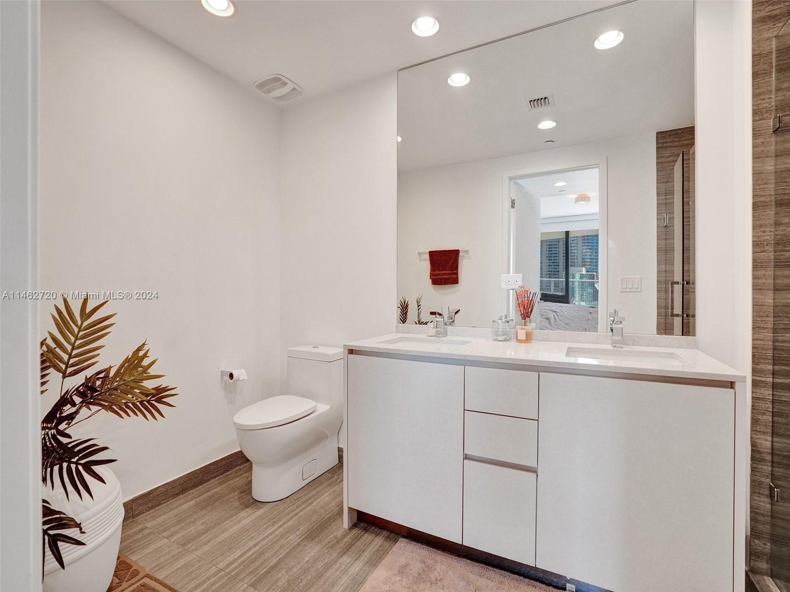 1010 Brickell Avenue, Unit 2505 Miami, FL 33131 - Photo 31 of 61 a bathroom with a sink toilet and mirror