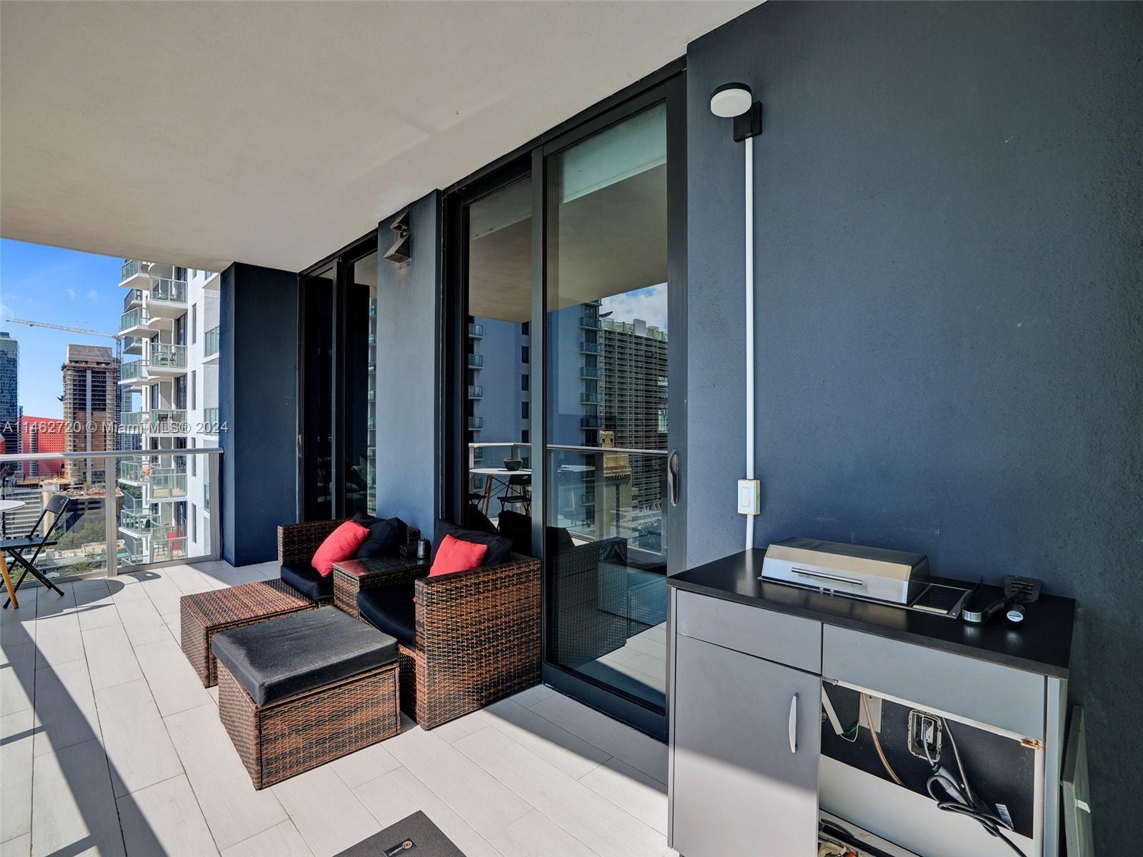 1010 Brickell Avenue, Unit 2505 Miami, FL 33131 - Photo 38 of 61 a living room with furniture and a floor to ceiling window