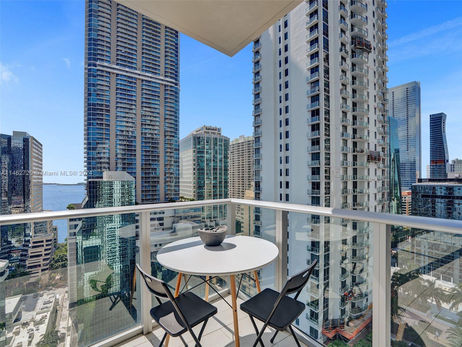 1010 Brickell Avenue, Unit 2505 Miami, FL 33131 - Photo 45 of 61 a balcony with a table and chairs