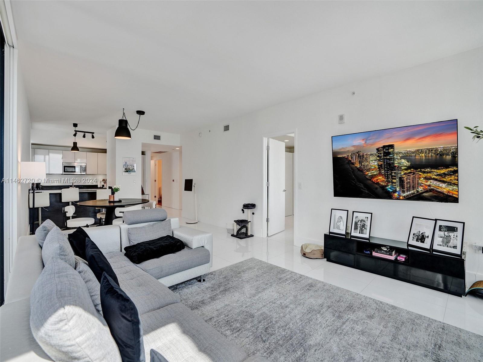 1010 Brickell Avenue, Unit 2505 Miami, FL 33131 - Photo 9 of 61 a living room with furniture and a flat screen tv