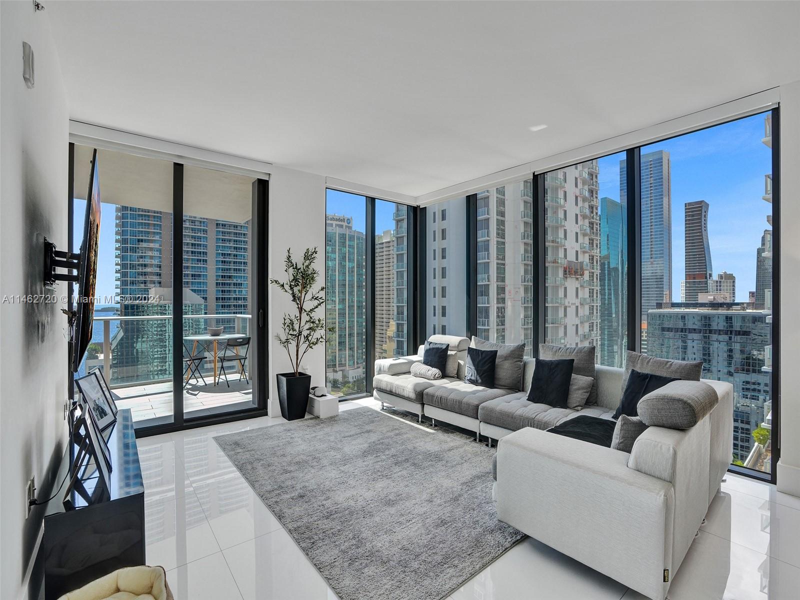 1010 Brickell Avenue, Unit 2505 Miami, FL 33131 - Photo 10 of 61 a living room with furniture and large windows