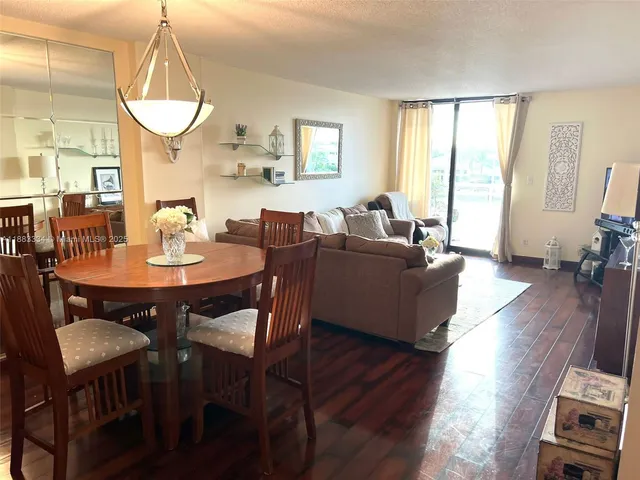 a view of a dining room with furniture wooden floor and a chandelier