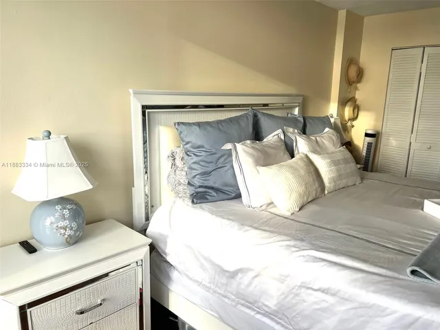 a bedroom with a bed and a mirror