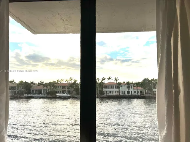 a bedroom with a bed and glass windows