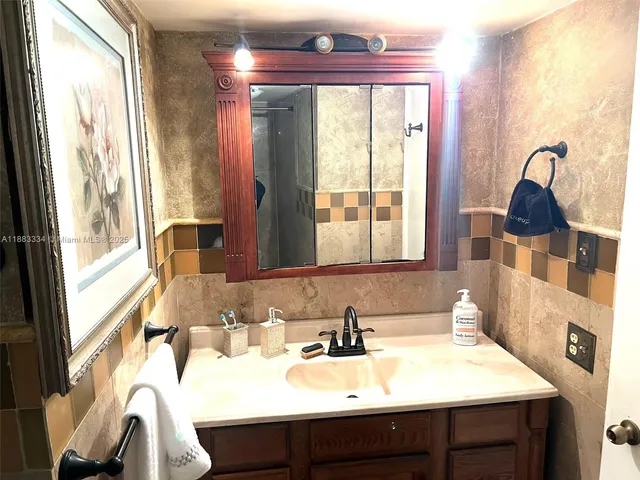 a bathroom with a sink toilet and a mirror