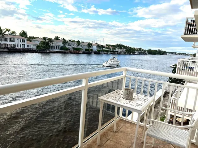 a view of a terrace with lawn chairs and wooden floor