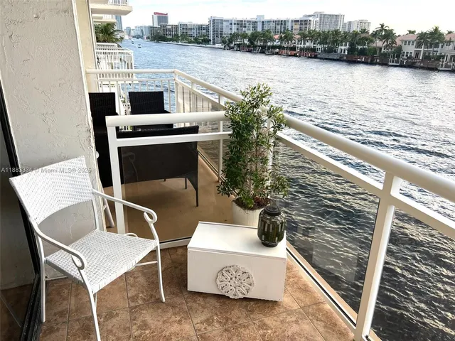 a balcony with table and chairs