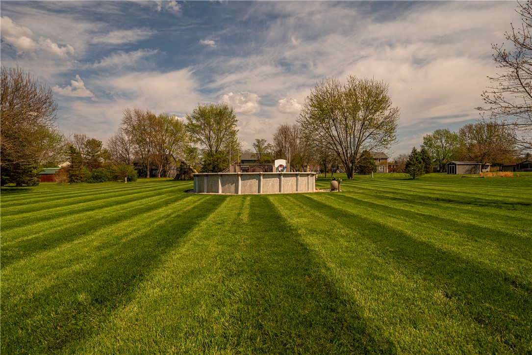 3628 Petre Road Springfield, OH 45502 - Photo 39 of 52 Expansive green space features a serene above-ground pool, perfect for outdoor recreation.