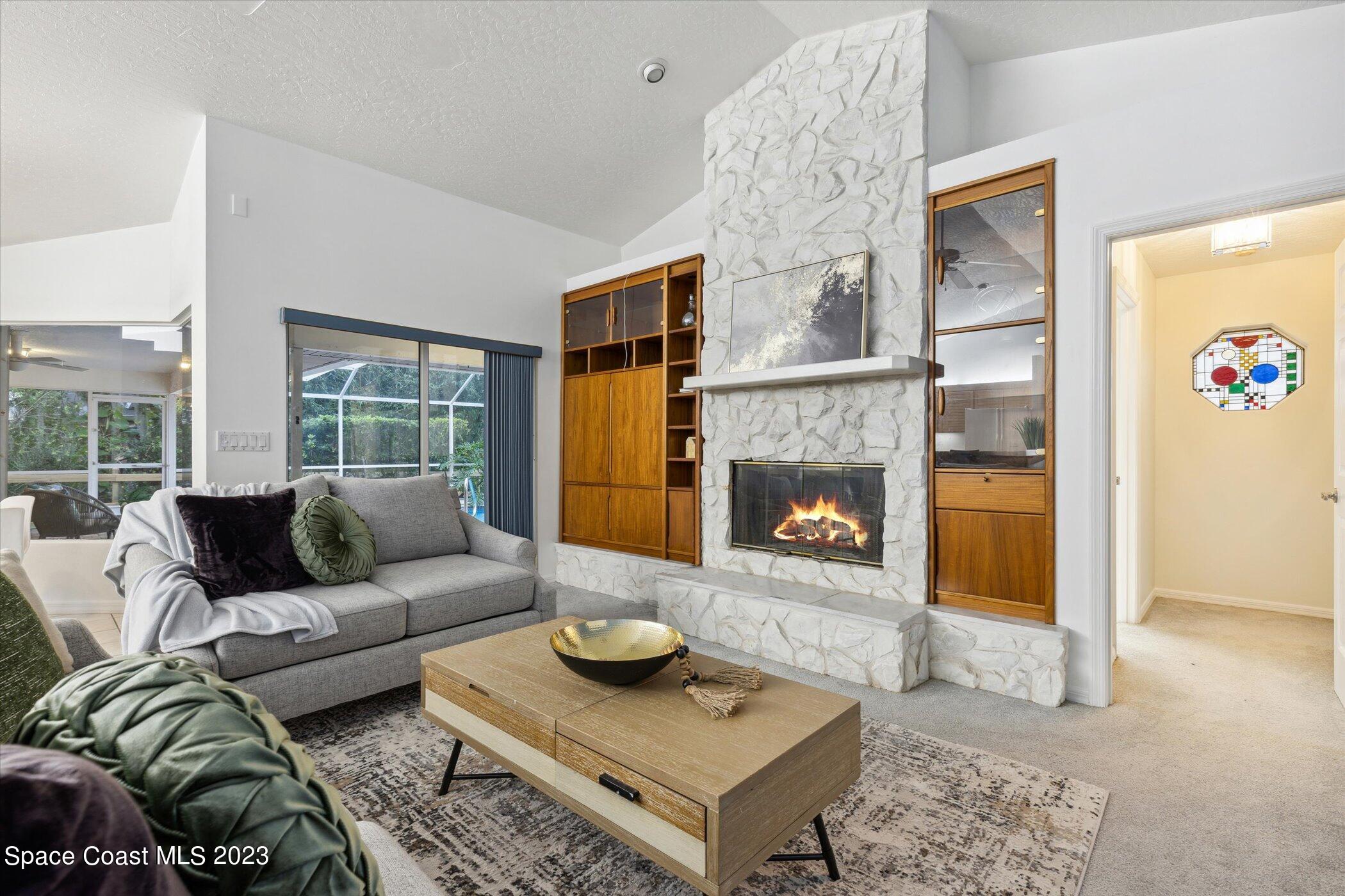4644 Canard Road Melbourne, FL 32934 - Photo 8 of 42 a living room with furniture and a fireplace
