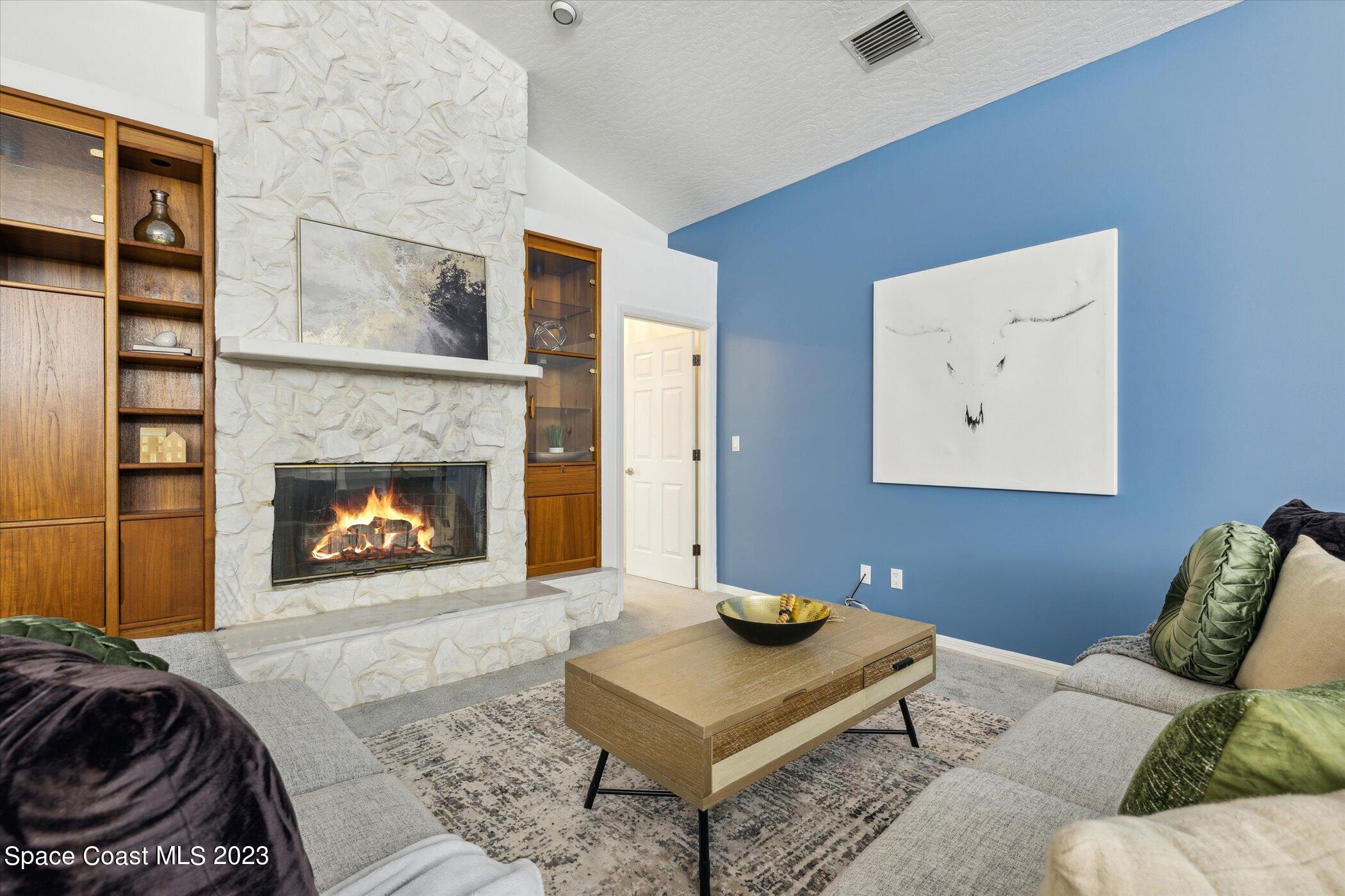 4644 Canard Road Melbourne, FL 32934 - Photo 9 of 42 a living room with furniture and a fireplace