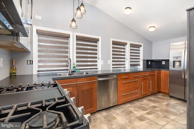 a view of a hallway with wooden floor and closet