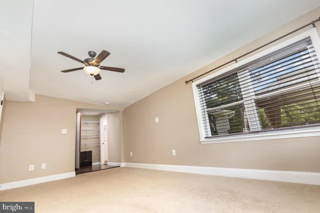 a view of a deck with chairs and wooden fence