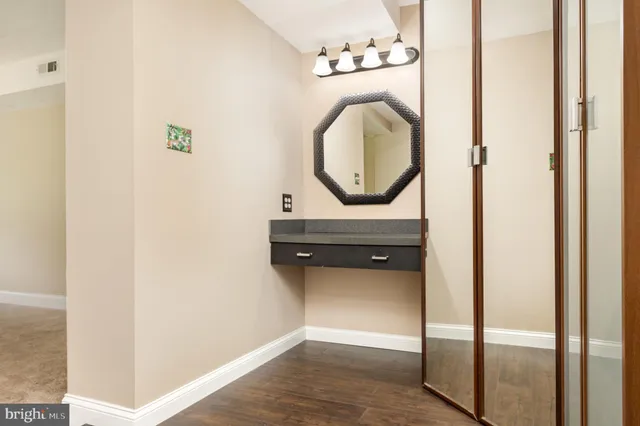 a view of a white house with a sink and backyard