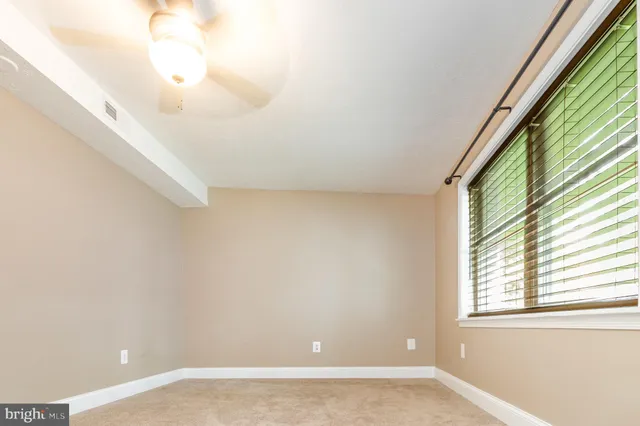 a view of a backyard with barn fence and large trees