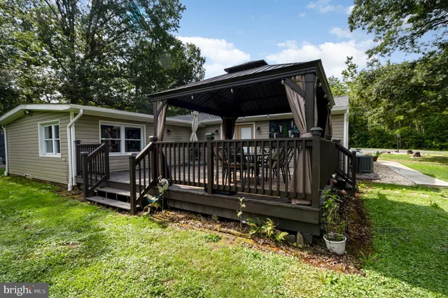 a view of a house with pool and a yard