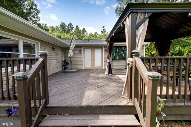 a view of backyard of house with green space