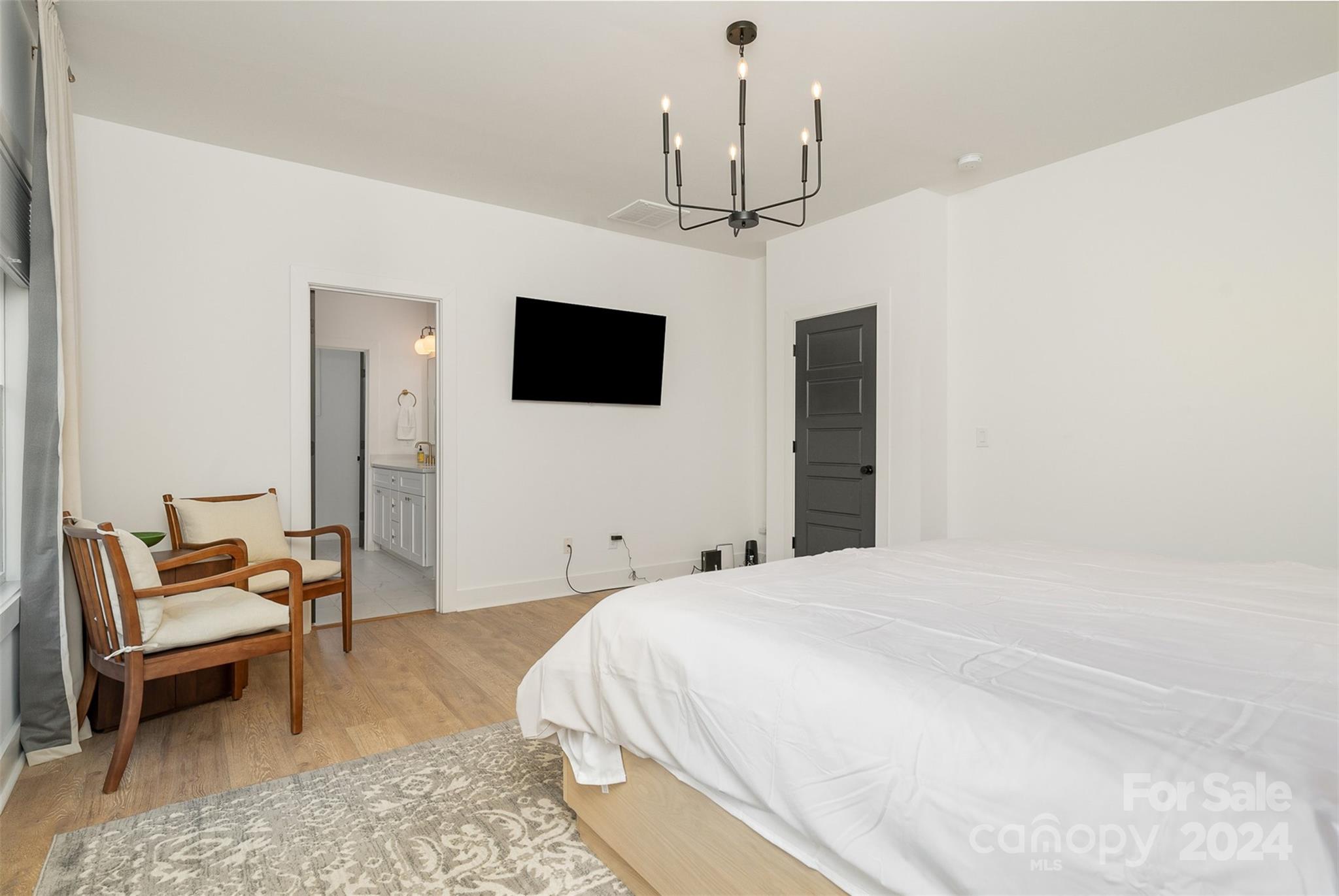 643 Tennyson Drive Charlotte, NC 28208 - Photo 12 of 42 a bedroom with a bed and a flat screen tv