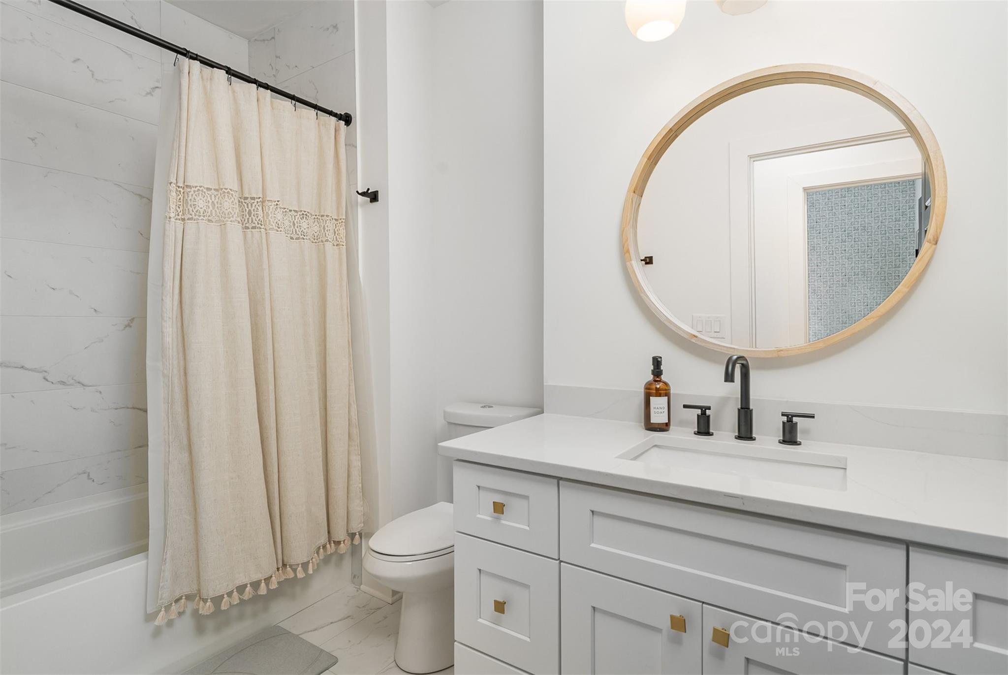 643 Tennyson Drive Charlotte, NC 28208 - Photo 18 of 42 a bathroom with a toilet a sink and a mirror