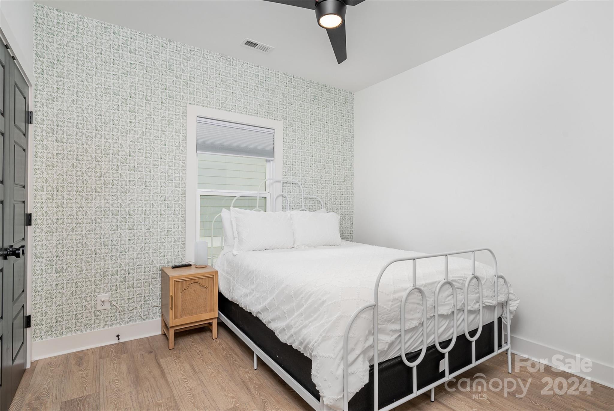 643 Tennyson Drive Charlotte, NC 28208 - Photo 19 of 42 a bedroom with a bed and a table
