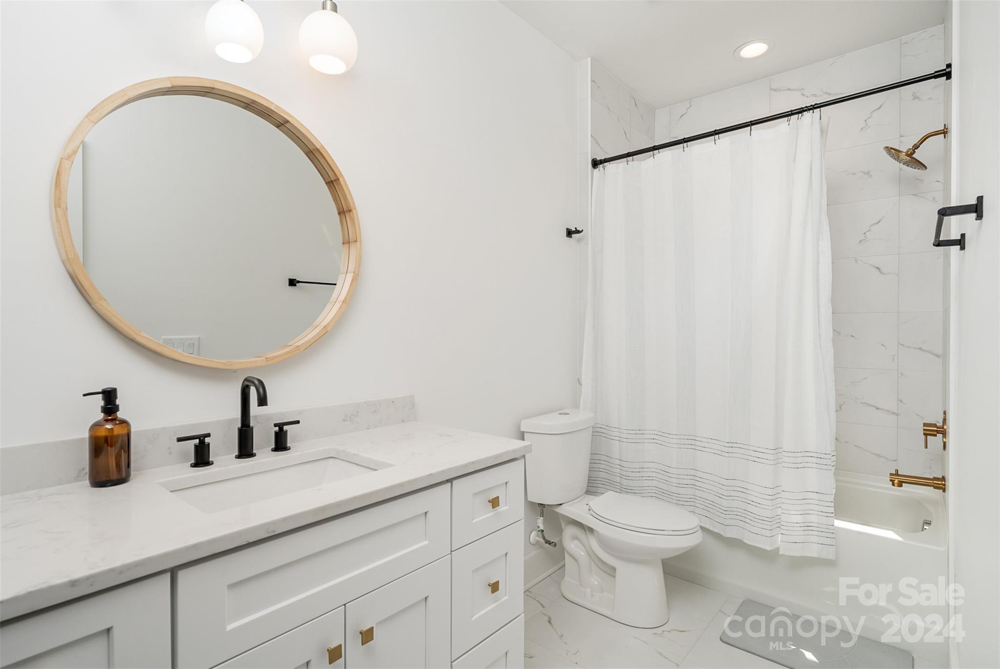 643 Tennyson Drive Charlotte, NC 28208 - Photo 22 of 42 a bathroom with a sink a toilet and a mirror