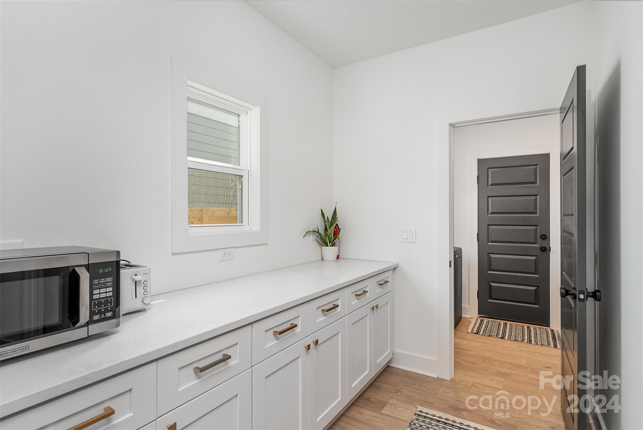 643 Tennyson Drive Charlotte, NC 28208 - Photo 27 of 42 a bathroom with a sink a potted plant and mirror