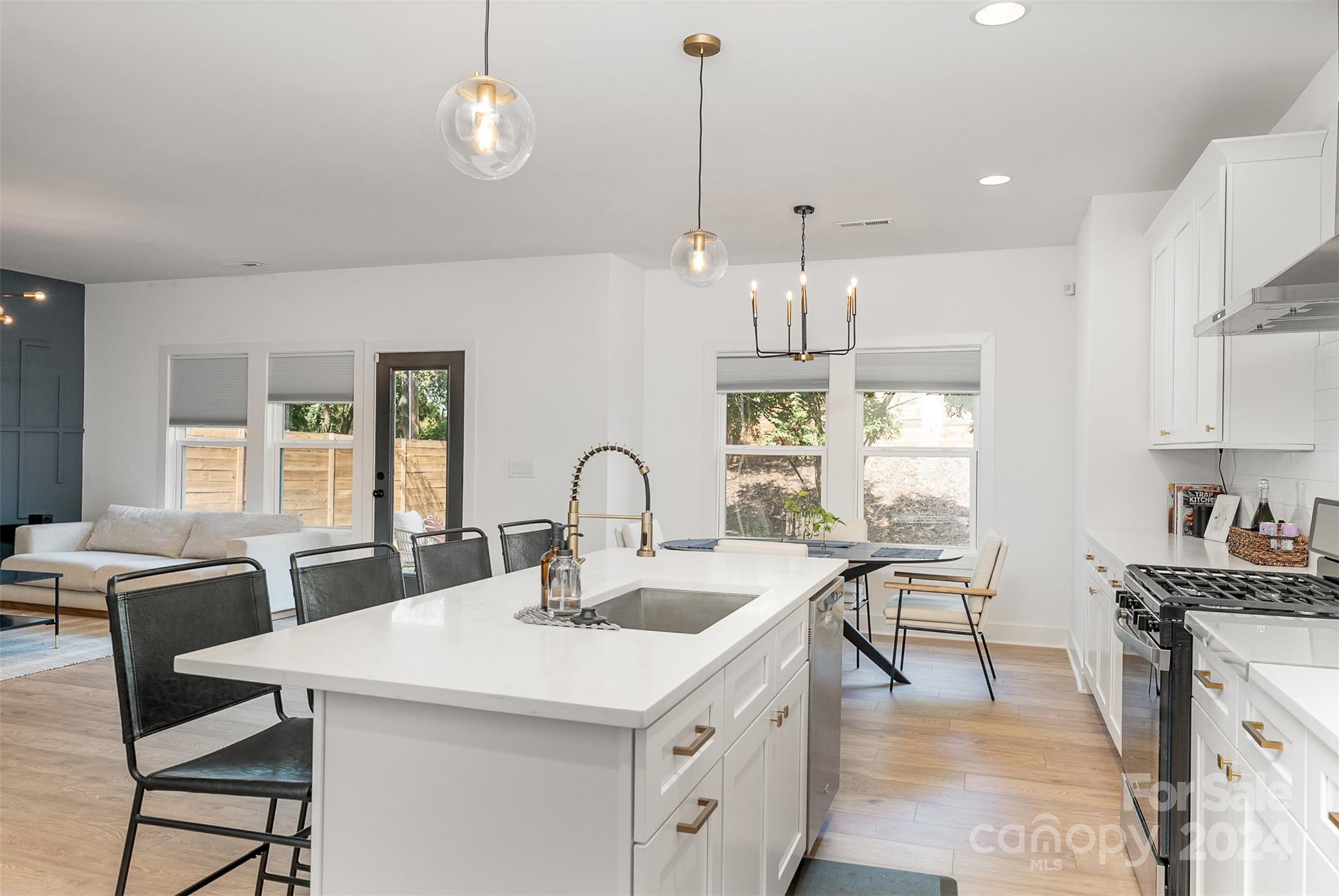 643 Tennyson Drive Charlotte, NC 28208 - Photo 29 of 42 a kitchen with stainless steel appliances a table chairs stove and kitchen view