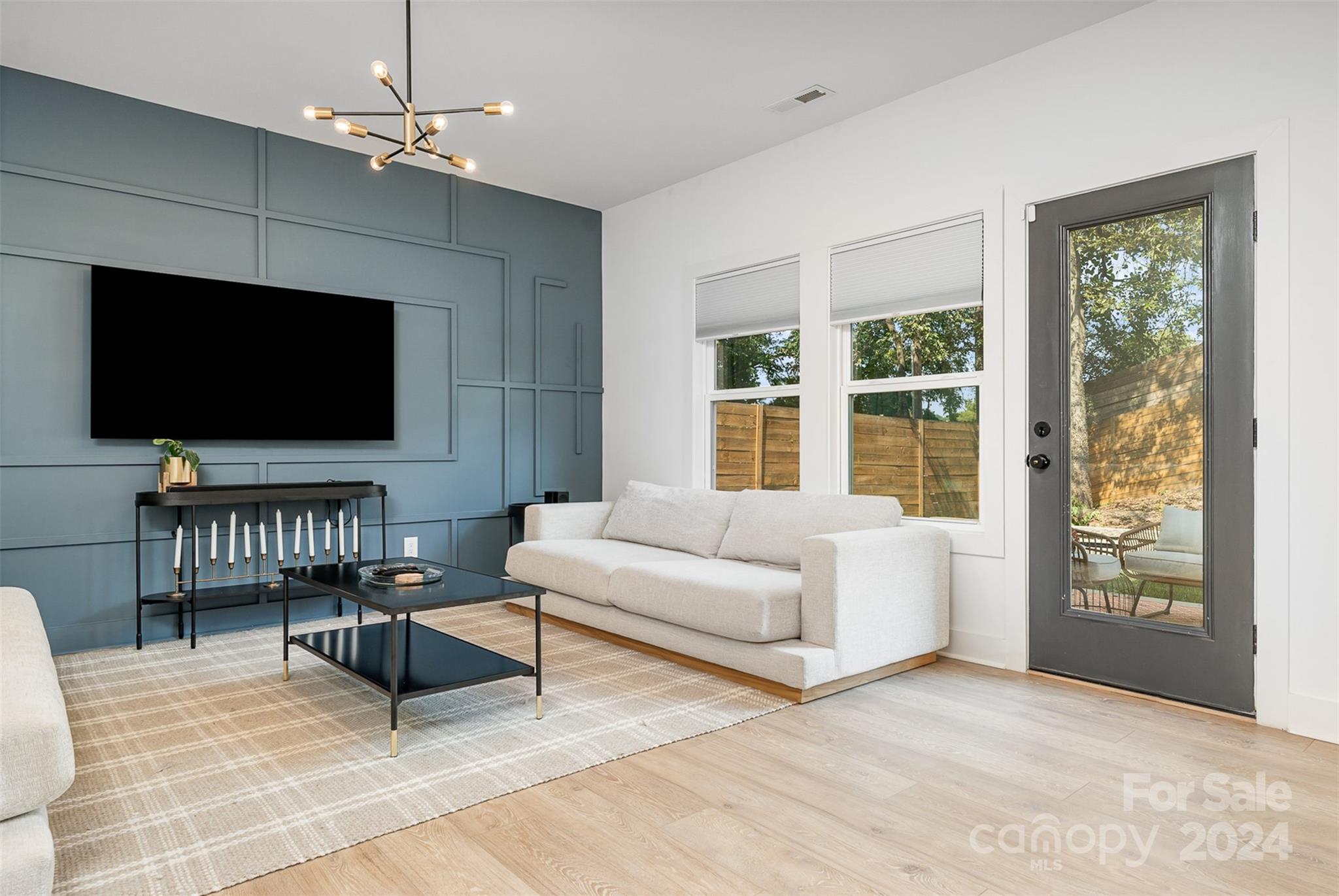 643 Tennyson Drive Charlotte, NC 28208 - Photo 33 of 42 a living room with furniture and a flat screen tv