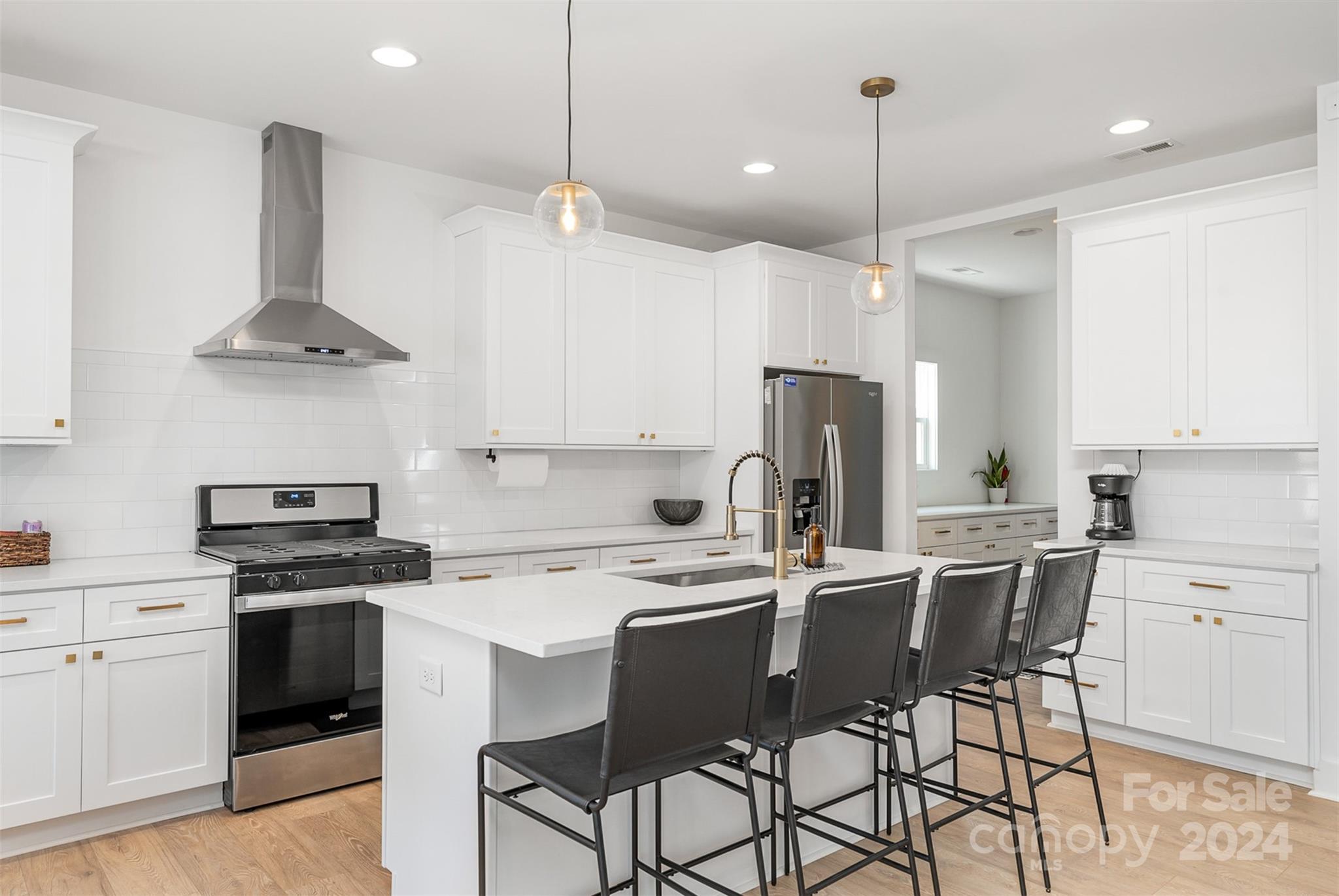 643 Tennyson Drive Charlotte, NC 28208 - Photo 5 of 42 a kitchen with stainless steel appliances a stove a sink refrigerator and a cabinets
