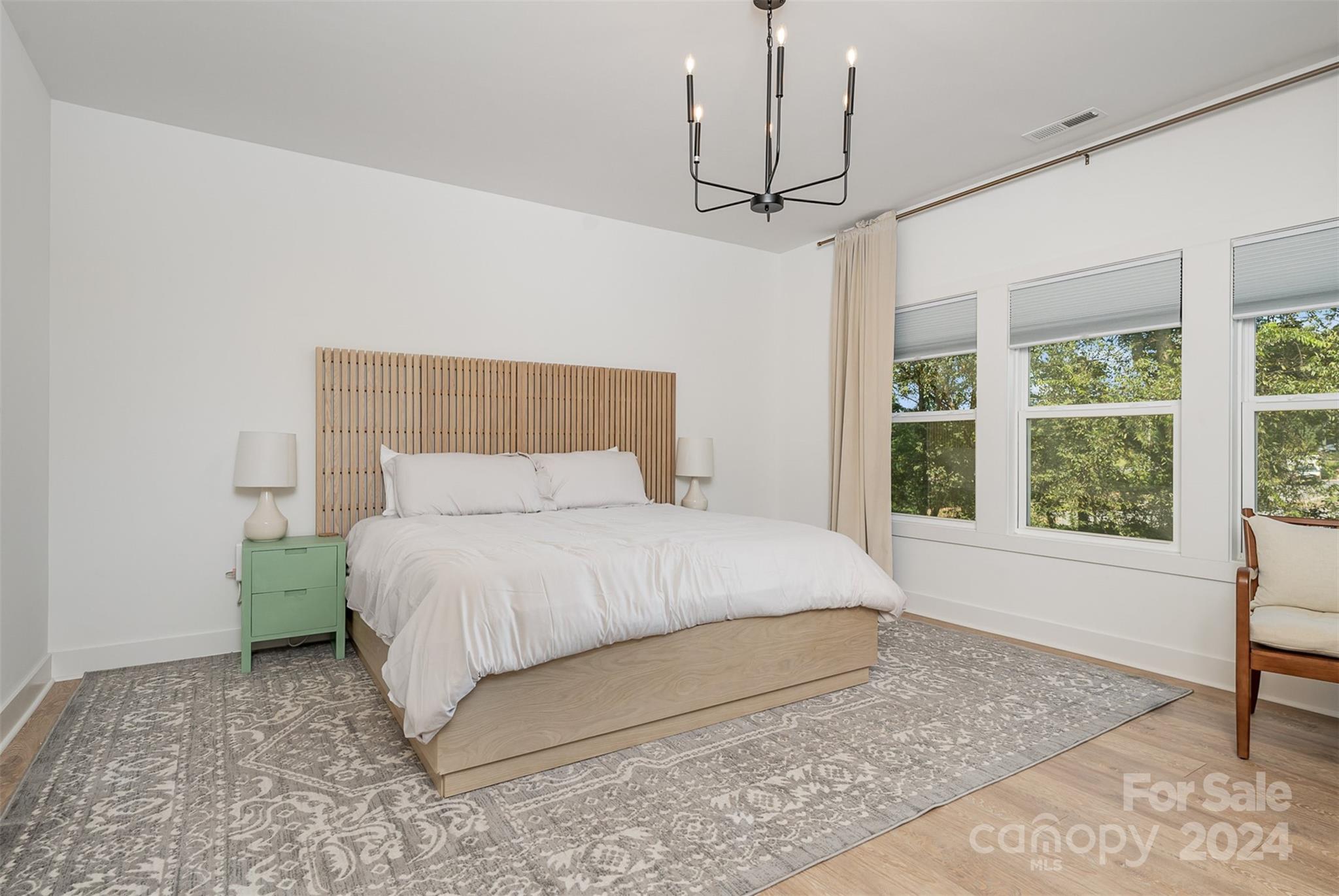 643 Tennyson Drive Charlotte, NC 28208 - Photo 7 of 42 a large bed sitting in a bedroom next to a window