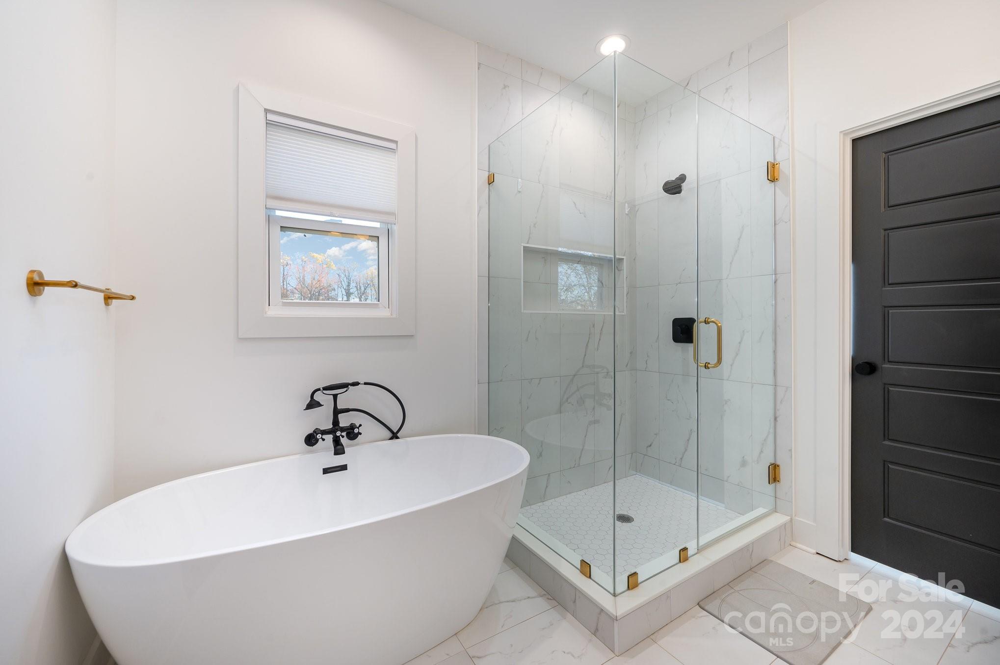 643 Tennyson Drive Charlotte, NC 28208 - Photo 8 of 42 a bathroom with a bathtub and shower