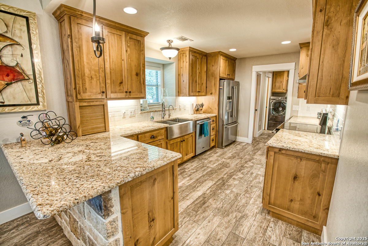 255 North Thunder Creek Road Utopia, TX 78884 - Photo 11 of 46 a spacious bathroom with a granite countertop sink a mirror and shower