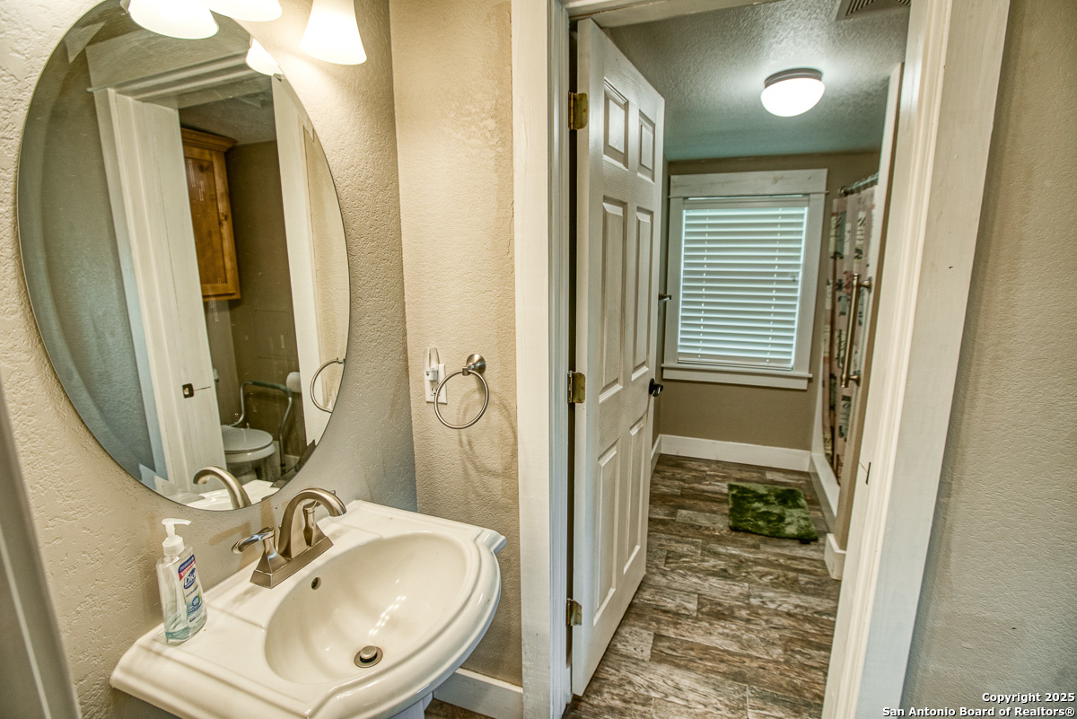 255 North Thunder Creek Road Utopia, TX 78884 - Photo 17 of 46 a bathroom with a sink a mirror and a shower