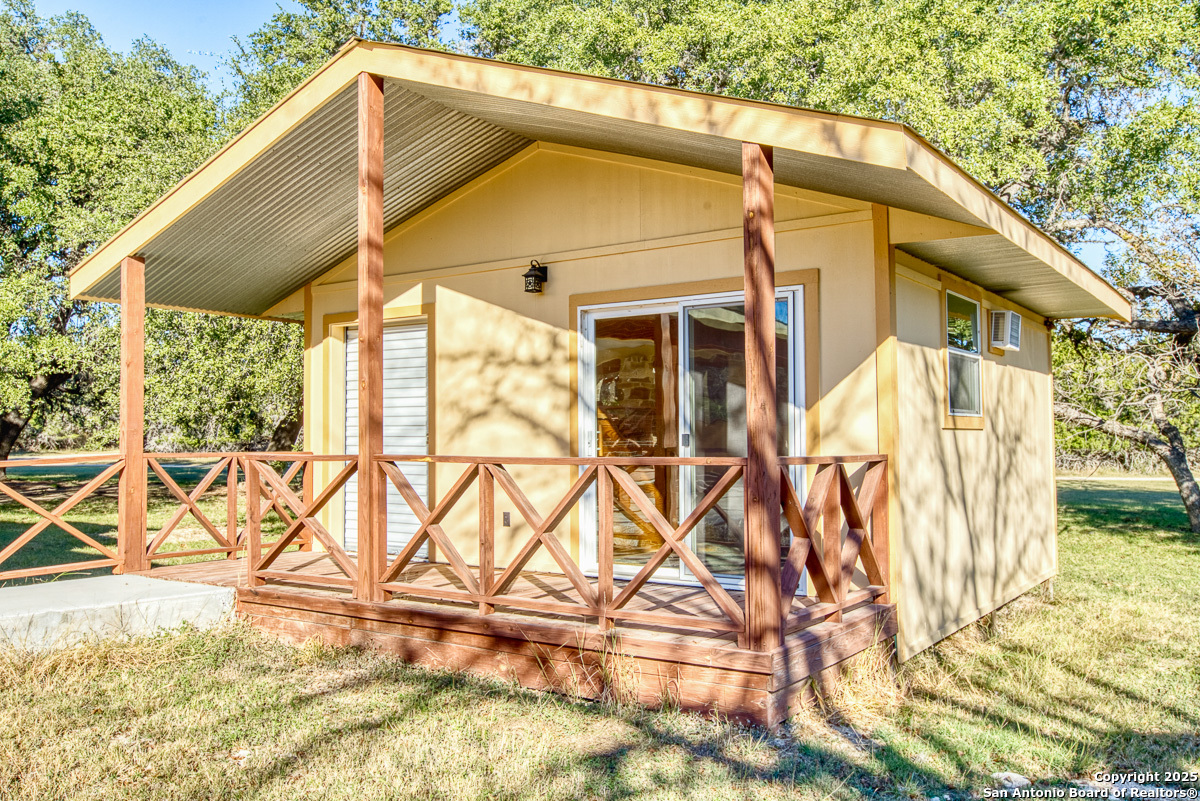 255 North Thunder Creek Road Utopia, TX 78884 - Photo 24 of 46 a blue and white umbrella sitting in front of a house