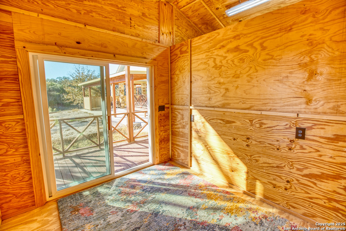 255 North Thunder Creek Road Utopia, TX 78884 - Photo 26 of 46 a view of a balcony with wooden floor and door