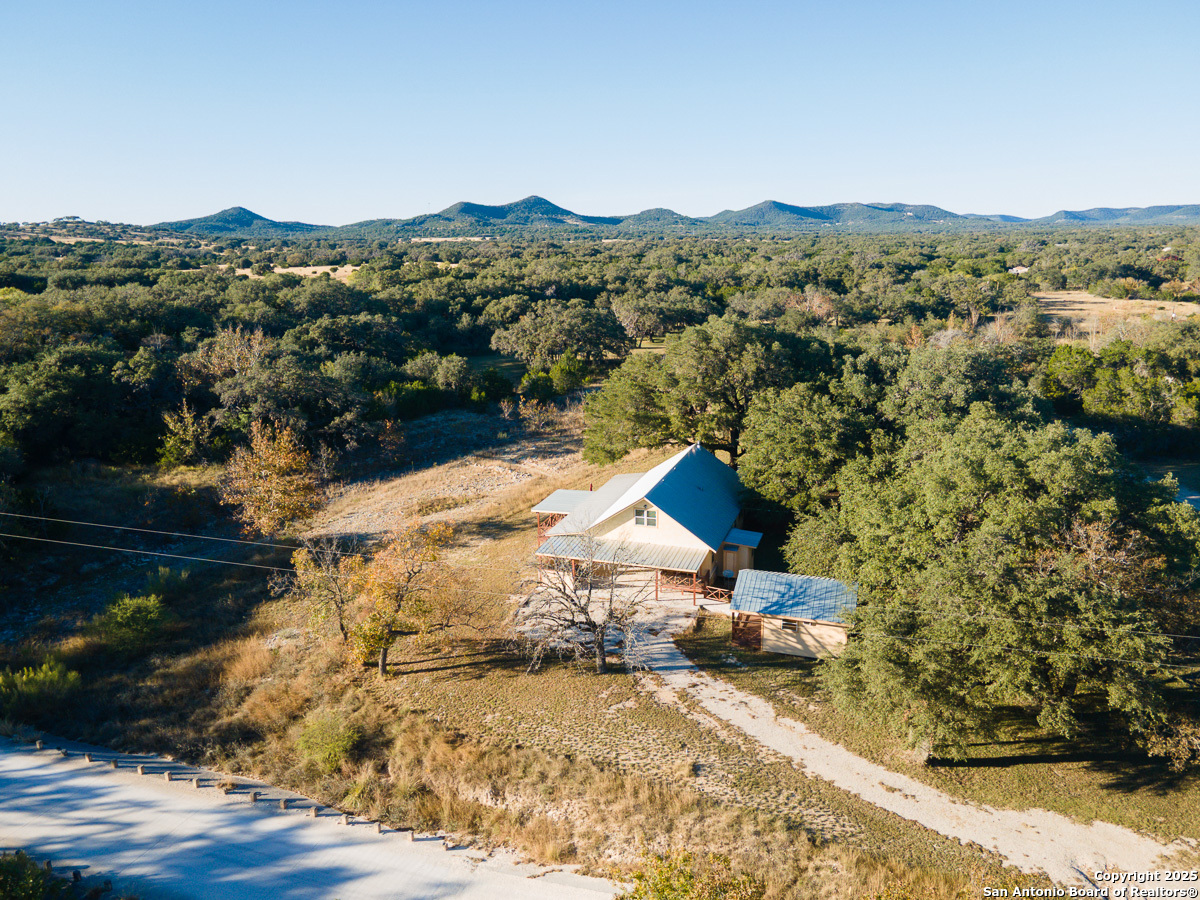 255 North Thunder Creek Road Utopia, TX 78884 - Photo 37 of 46 a view of a house with a yard