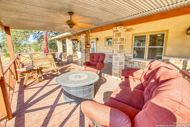 a view of a patio with table and chairs and potted plants