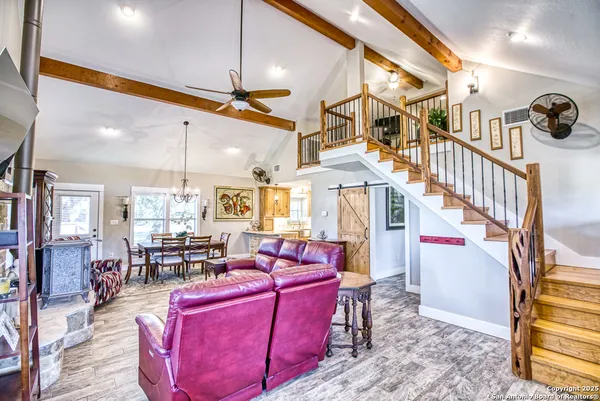 a living room with fireplace furniture and a flat screen tv