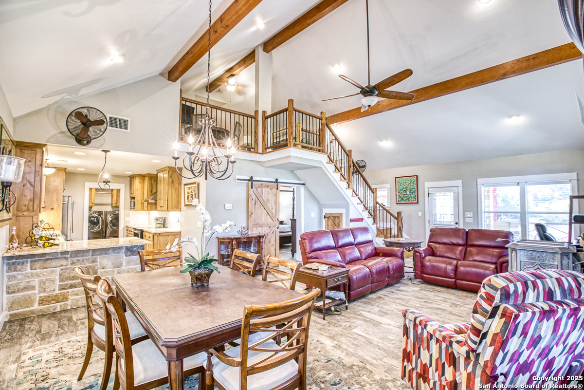 255 North Thunder Creek Road Utopia, TX 78884 - Photo 8 of 46 a living room with furniture a couch and a chandelier