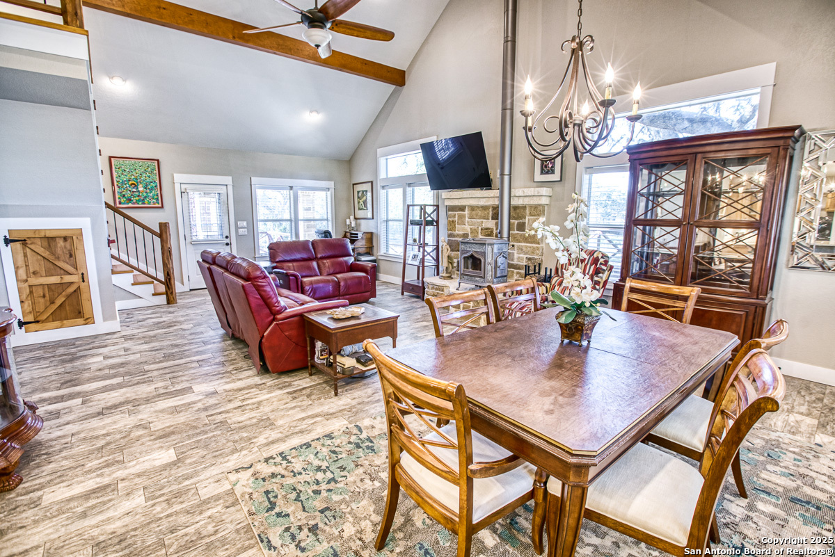 255 North Thunder Creek Road Utopia, TX 78884 - Photo 9 of 46 a view of a dining room with furniture a chandelier and wooden floor